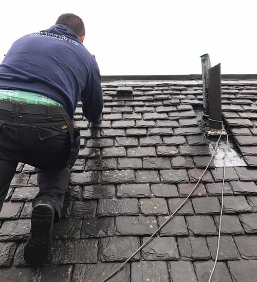 slate roof being repaired